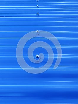 Blueish metallic corrugated sheet roof texture. Deep blue profiled sheet panel. Corrugated Metal Roof Exterior Close up