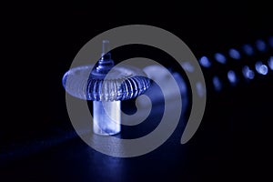 Blueish mouse scroller wheel on dark surface photo