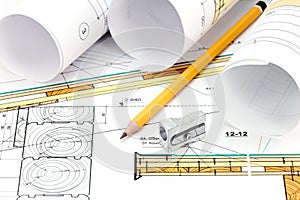 Blueprint rolls with technical drawings and pencil on table