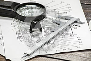 Blueprints analisys with a magnithing glass and a calipers