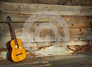 Blues guitar the old wooden wall as background