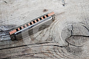 Blues harmonica on a wooden background