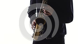 Blues on the saxophone. Musician playing solo in white studio