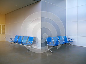 Blues waiting row chair on concrete polishing floor and grey aluminium composite wall back ground.