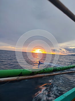 Bluesea sunset inside green boat