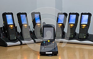Bluetooth barcode scanners are charging on the table. use for the work in the warehouse and logistics line. the technology works photo