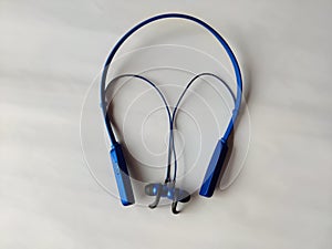 A Bluetooth headset blue color isolated on white background closeup view