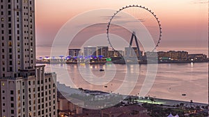 Bluewaters island with modern architecture and ferris wheel aerial day to night timelapse.