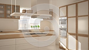 Blur background interior design, modern wooden and white kitchen with island, stools and windows, parquet herringbone floor