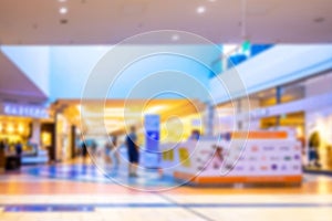 Blur background interior of retail centre store in soft focus. People shopping in modern commercial mall center. Sale, consumerism