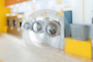 Blur background of qualified coin-operated washing machines in a public store.