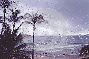 Blur background tropical island storm rain on window