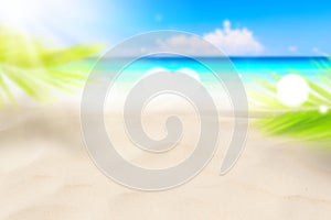 Blur beautiful nature green palm leaf on tropical beach with bokeh sun light wave abstract background