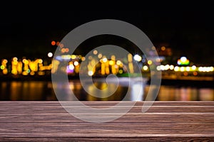 Blur cafe restaurant or resort close to the sea empty of dark wood table with blurred light gold bokeh abstract background for