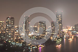 Blur city background rooftop view of Bangkok cityscape business building landscape night lights bokeh