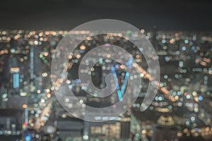 Blur city background rooftop view of Bangkok cityscape business building landscape night lights bokeh