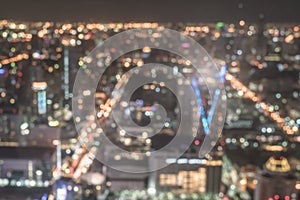 Blur city background rooftop view of Bangkok cityscape business building landscape night lights bokeh