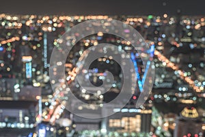 Blur city background rooftop view of Bangkok cityscape business building landscape night lights bokeh