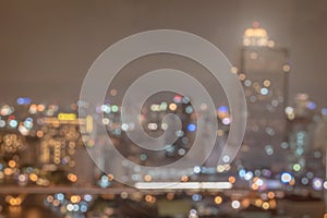 Blur city background rooftop view of Bangkok cityscape business building landscape night lights bokeh in dark tone