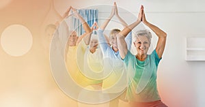 Blur effect with copy space against female yoga trainer and group of senior people performing yoga