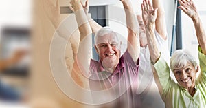 Blur effect with copy space against group of senior people performing yoga at retirement home