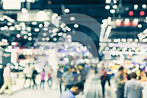 Blur event hall in large exhibition center with people walking background people