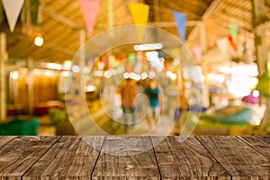 Blur festival background with wooden table top