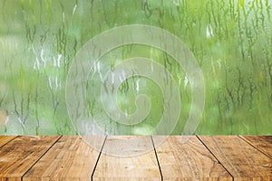 Blur fresh wet moist green nature with wooden table foreground