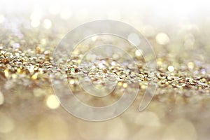 Blur Gold (bronze) glitter shine dots confetti. Abstract light blink sparkle defocus backgound