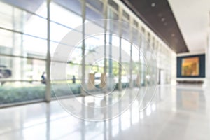 Blur hotel or office lobby background interior view toward reception hall, modern luxury white room space