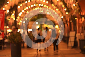 blur image of night festival in a restaurant and market street walk with bokeh for background