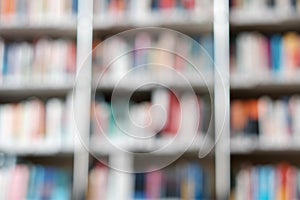 Blur image of shelf with books in library. Background