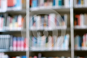 Blur image of shelf with books in library. Background