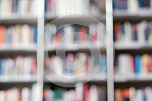 Blur image of shelf with books in library. Background