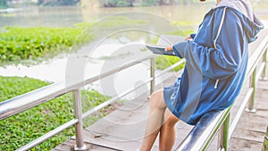 Blur image , A young woman is reading and learning the teachings of God from the Bible that she holds in her hand, with faith and