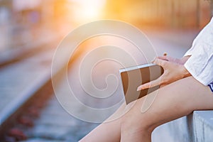 Blur image , A young woman is reading and learning the teachings of God from the Bible that she holds in her hand, with faith and