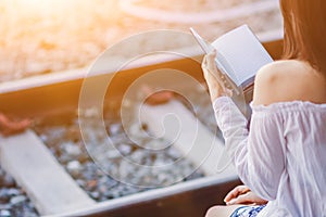 Blur image , A young woman is reading and learning the teachings of God from the Bible that she holds in her hand, with faith and