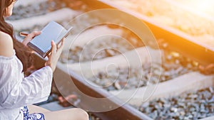 Blur image , A young woman is reading and learning the teachings of God from the Bible that she holds in her hand, with faith and