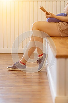 Blur image , A young woman is reading and learning the teachings of God from the Bible that she holds in her hand, with faith and