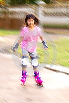 Blur motion background. Asian girl playing rollerblading at home