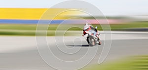 Blur motion of motorcycle racer on a track