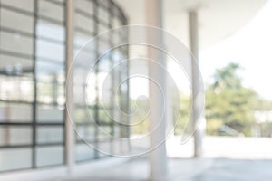 Blur office background building exterior view to lobby glass window wall with blurry light bokeh