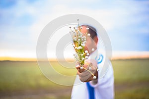 Blur people is holding abeautiful bouquet of autumn grass flowe