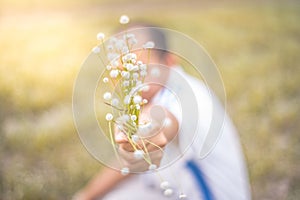 Blur people is holding abeautiful bouquet of autumn grass flowe