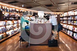 Blur People reading at table counter Bookstore Interior