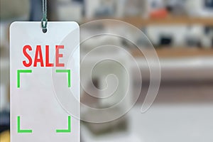 Blur photo - abstract image for the background. Sale signs in shop window,Sale promotion notice in the shopping mall.