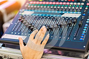 Blur Photo Hand adjusting audio mixer. sound engineer hands working on sound mixer in live concert.