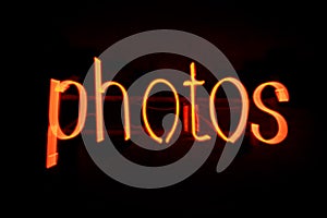 Blur Photos message in red neon against black background - Image