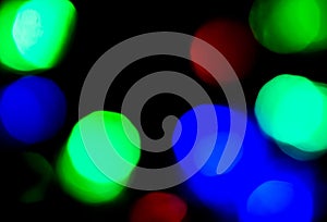 Blur red, blue and green light on dark background for Christmas concept