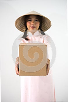 Blur smiling woman beautiful pink dress hands holding brown box